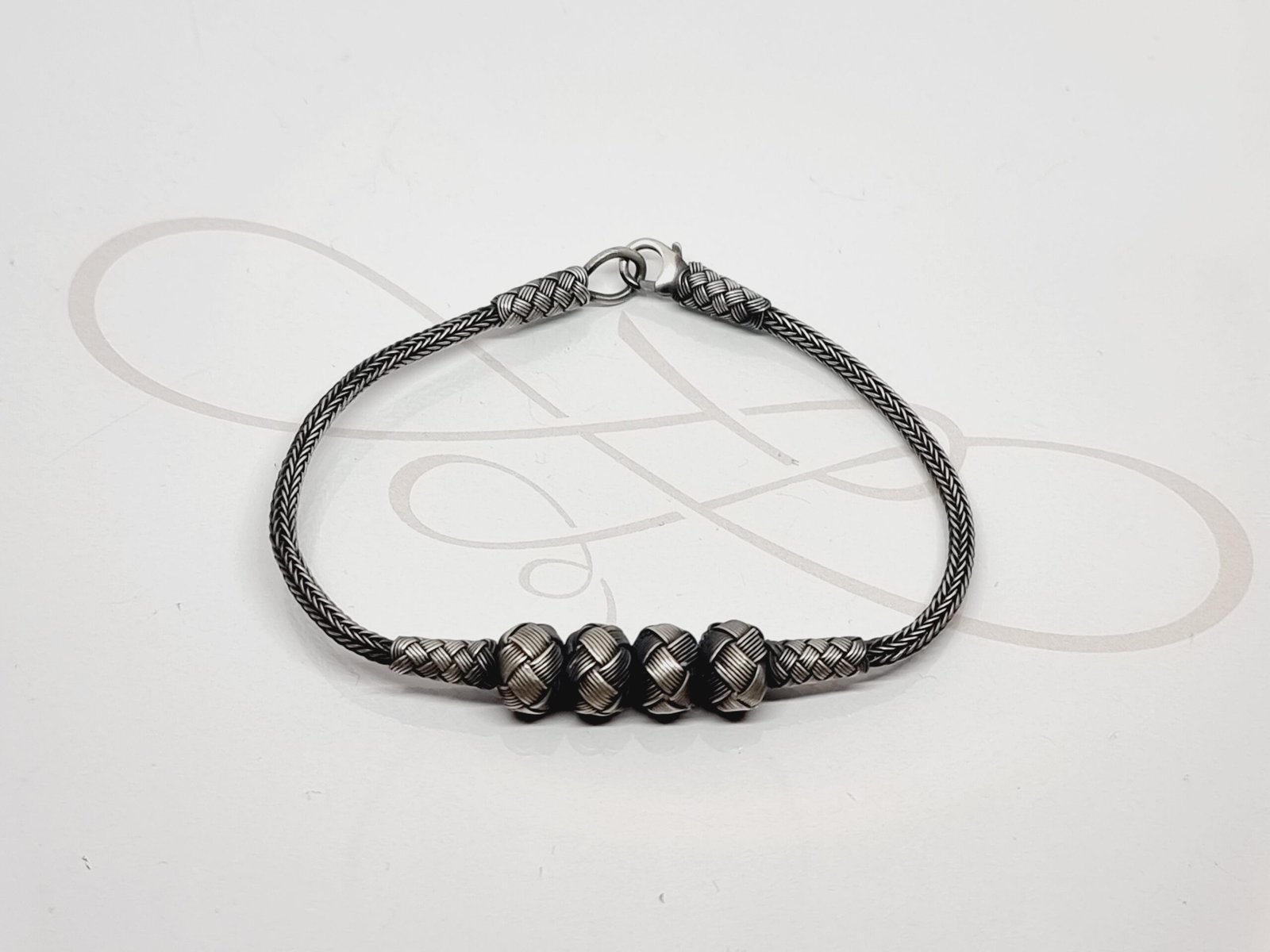 PULSERA CUATRO BOLAS PLATA PAVONADA