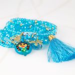 PULSERA CON DIJE ORO LAMINADO BARRO POMPON CRISTAL