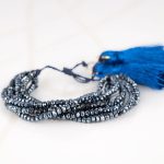 PULSERA SIN DIJE ORO LAMINADO HILOS POMPON CRISTAL