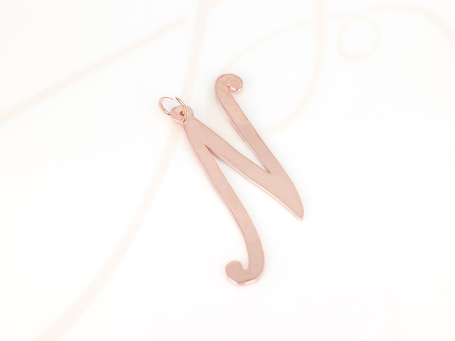 DIJE RECUBRIMIENTO DE ORO ROSA CURSIVA N LISO